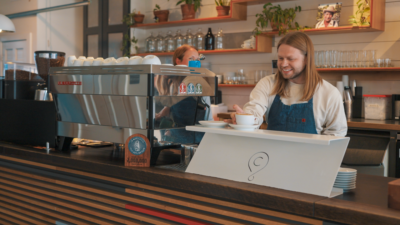 Barista serving coffee